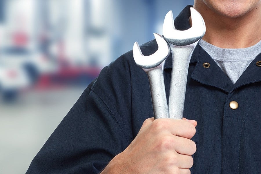 Mechanic holding wrenches