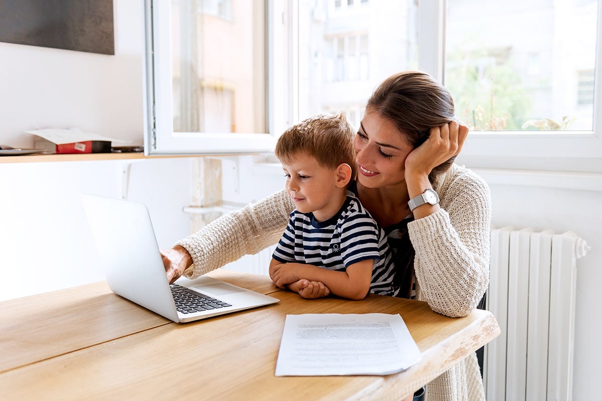 Woman and child looking at a laptop
